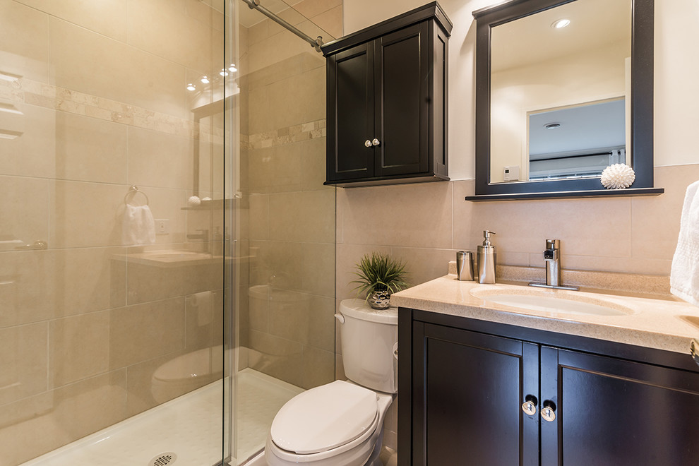 Inspiration for a small contemporary master beige tile and porcelain tile porcelain tile alcove shower remodel in Montreal with an undermount sink, shaker cabinets, dark wood cabinets, solid surface countertops, a two-piece toilet and beige walls