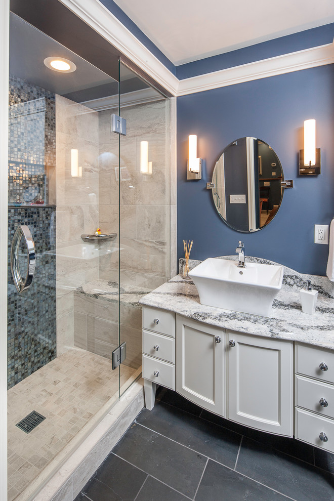 Example of a mid-sized classic 3/4 beige tile and travertine tile porcelain tile and black floor alcove shower design in Minneapolis with recessed-panel cabinets, white cabinets, blue walls, a vessel sink, quartz countertops and a hinged shower door