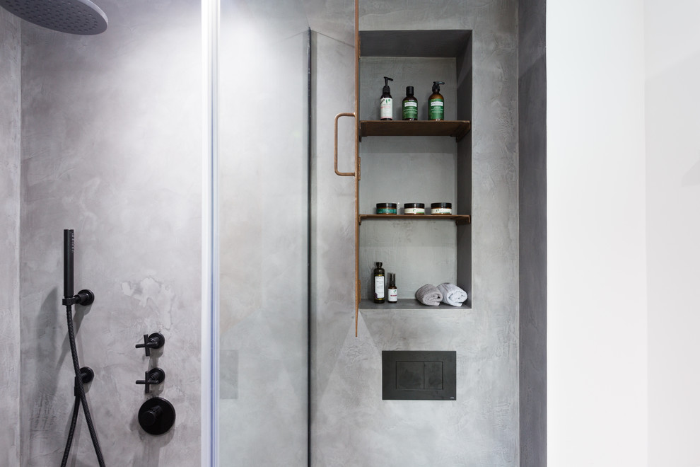 Inspiration for a small industrial master gray tile concrete floor and gray floor doorless shower remodel in London with beaded inset cabinets, brown cabinets, a wall-mount toilet, gray walls, a wall-mount sink and a hinged shower door
