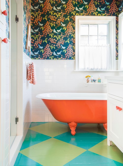 Citrus Splash: Orange Bathtub with Floral Wallpaper and White Subway Tiles