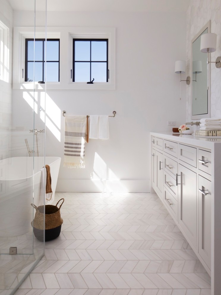 Medium sized classic ensuite bathroom in San Francisco with shaker cabinets, beige cabinets, a freestanding bath, a built-in shower, a one-piece toilet, white tiles, marble tiles, white walls, marble flooring, a submerged sink, engineered stone worktops, white floors, a hinged door and white worktops.