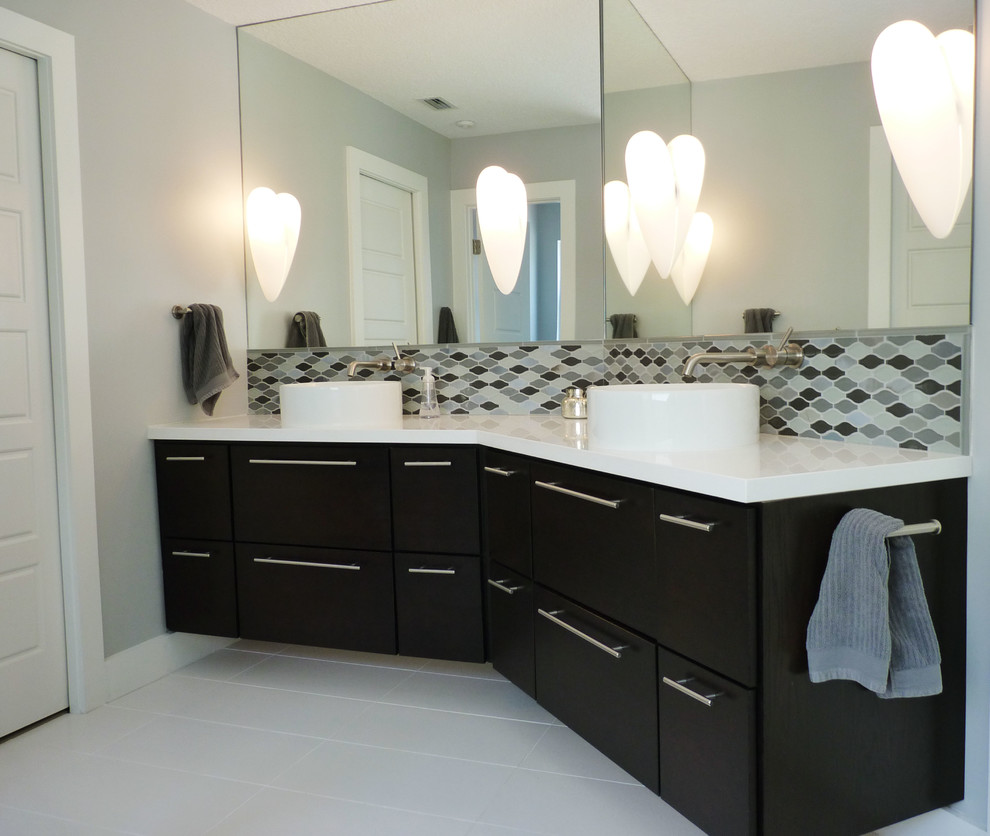This is an example of a medium sized coastal ensuite bathroom in Jacksonville with a vessel sink, flat-panel cabinets, dark wood cabinets, white tiles and white walls.