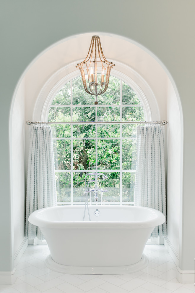 Example of a trendy master white floor freestanding bathtub design in Jacksonville with white walls