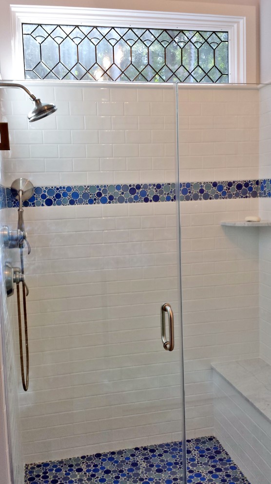 This is an example of a large classic bathroom in New York with an alcove shower, white tiles, ceramic tiles, mosaic tile flooring, blue floors and a hinged door.