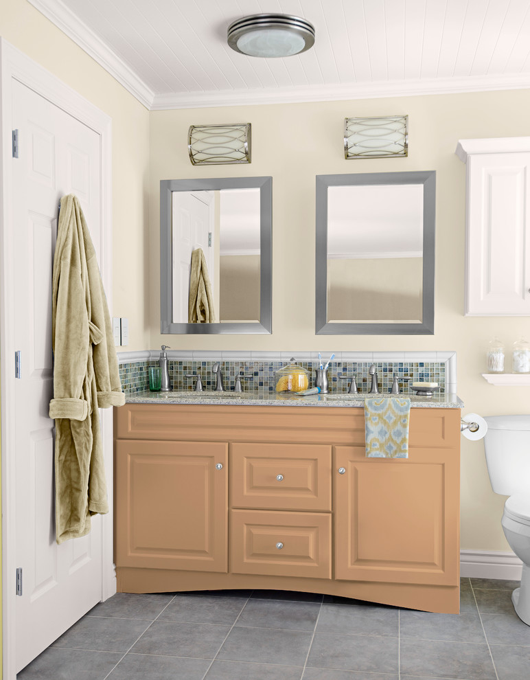 Inspiration for a mid-sized transitional master multicolored tile and mosaic tile ceramic tile bathroom remodel in Charlotte with an undermount sink, raised-panel cabinets, orange cabinets, granite countertops, a two-piece toilet and white walls