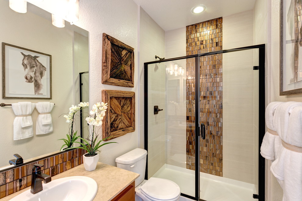 Alcove shower - mid-sized rustic 3/4 brown tile and mosaic tile alcove shower idea in Sacramento with flat-panel cabinets, dark wood cabinets, a two-piece toilet, beige walls, a drop-in sink, quartz countertops and a hinged shower door