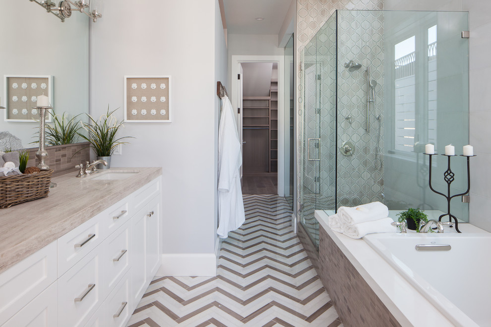 Inspiration for a traditional ensuite bathroom in Orange County with shaker cabinets, white cabinets, a built-in bath, a corner shower, beige tiles, grey walls, a submerged sink and a hinged door.