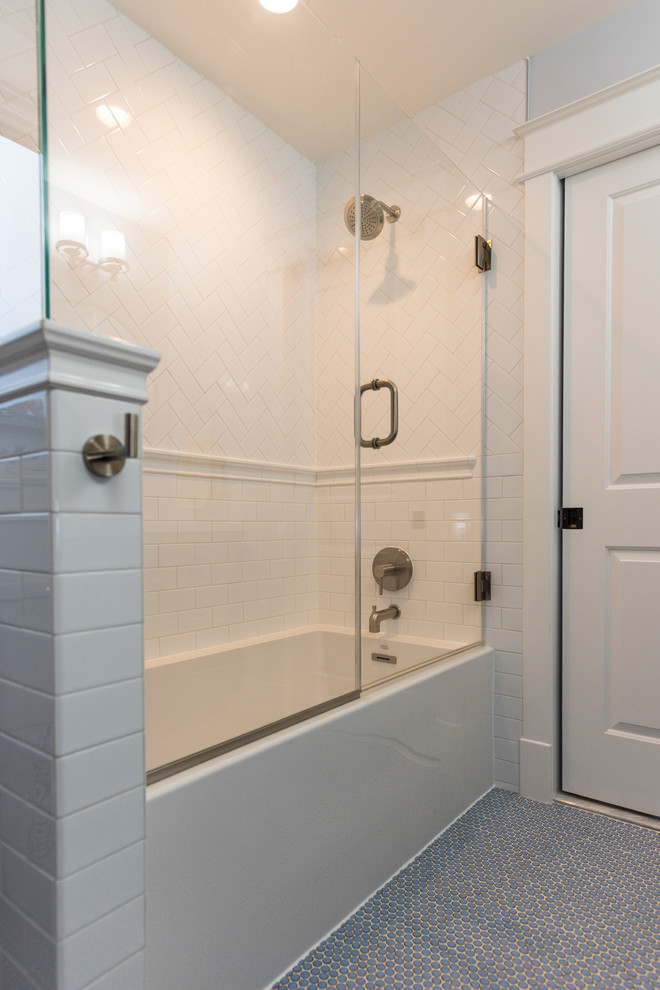 Mid-sized arts and crafts 3/4 white tile and subway tile blue floor bathroom photo in DC Metro with recessed-panel cabinets, dark wood cabinets, gray walls, an undermount sink, quartz countertops and a hinged shower door