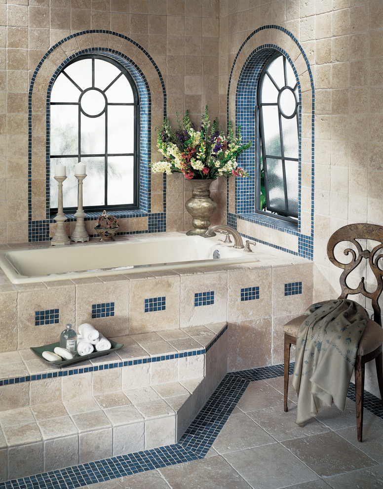 Large mediterranean ensuite bathroom in Seattle with a built-in bath, blue tiles, mosaic tiles, beige walls and porcelain flooring.