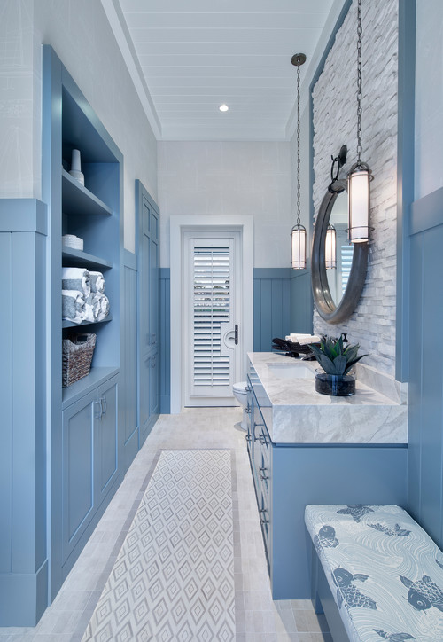 Pastel Perfection: Pastel Blue Vanity with a Marble Countertop and White Brick Backsplash