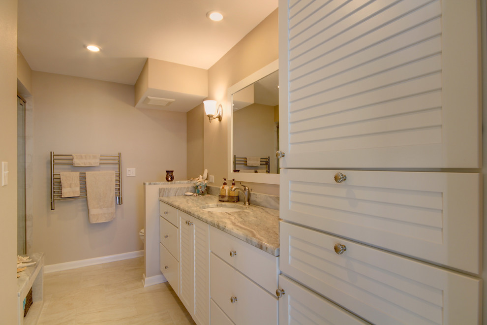 Beach style multicolored tile and porcelain tile alcove shower photo in Miami with an undermount sink, louvered cabinets, white cabinets, granite countertops and a two-piece toilet