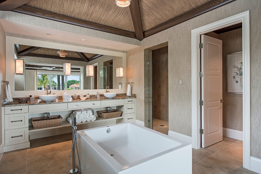 マイアミにあるラグジュアリーな巨大なアジアンスタイルのおしゃれな浴室 (ベッセル式洗面器、シェーカースタイル扉のキャビネット、ベージュのキャビネット、御影石の洗面台、茶色いタイル、白い壁) の写真