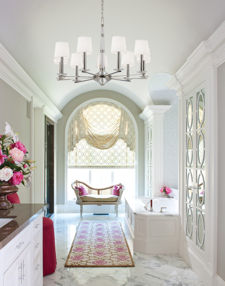 Elegant master bathroom photo in New York with recessed-panel cabinets, white cabinets, an undermount tub and beige walls
