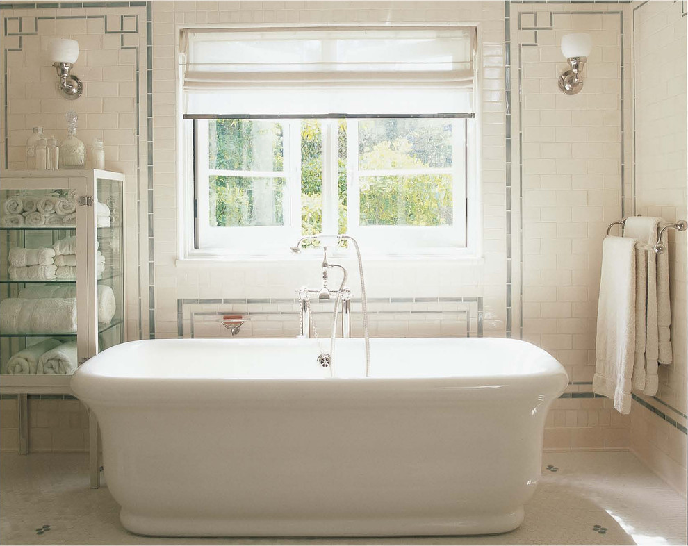 Classic bathroom in London with a freestanding bath, white tiles, ceramic tiles and white walls.