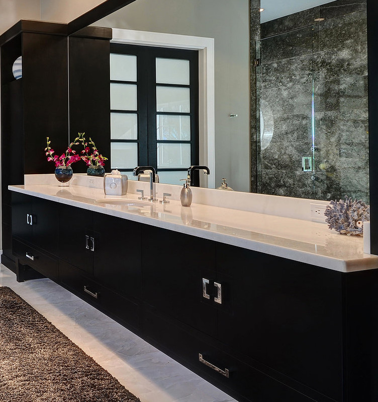 Large contemporary ensuite bathroom in Miami with flat-panel cabinets, black cabinets, an alcove shower, beige walls, marble flooring, a submerged sink and engineered stone worktops.