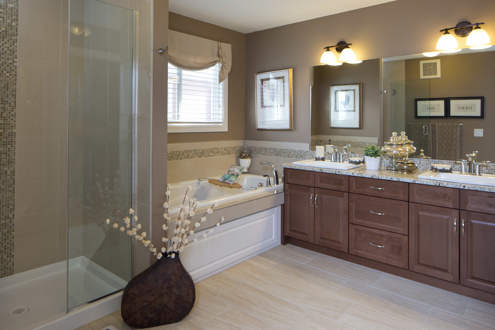 Medium sized traditional bathroom in Edmonton with a built-in sink, raised-panel cabinets, medium wood cabinets, granite worktops, a built-in bath, an alcove shower, a two-piece toilet, beige tiles, ceramic tiles, brown walls and ceramic flooring.