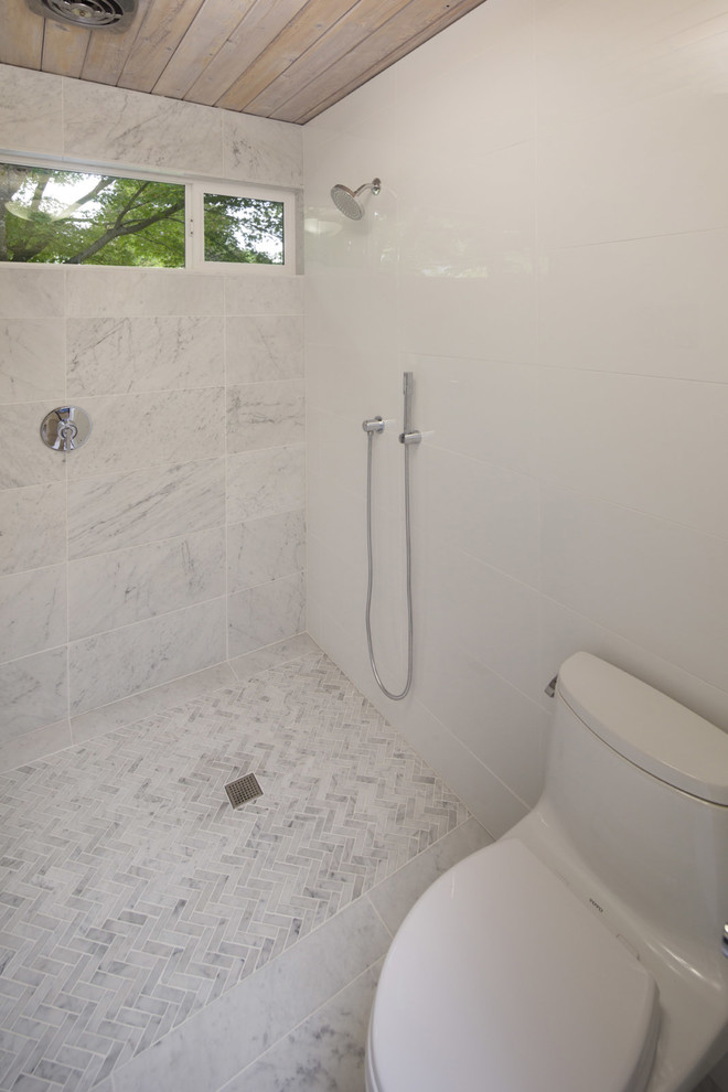 Inspiration for a mid-sized 1960s master multicolored tile and marble tile marble floor and multicolored floor bathroom remodel in Portland with flat-panel cabinets, medium tone wood cabinets, a one-piece toilet, white walls, an undermount sink, solid surface countertops and gray countertops