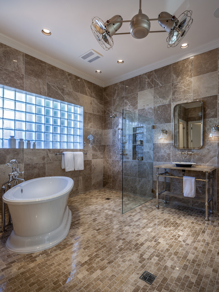 Contemporary ensuite bathroom in Dallas with a vessel sink, marble worktops, a freestanding bath, a built-in shower, a one-piece toilet, brown tiles, ceramic tiles, brown walls and ceramic flooring.