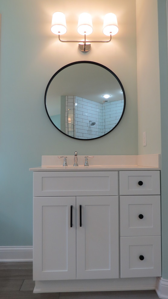 Пример оригинального дизайна: большая главная ванная комната в стиле модернизм с фасадами в стиле шейкер, белыми фасадами, отдельно стоящей ванной, двойным душем, белой плиткой, керамической плиткой, зелеными стенами, полом из керамогранита, монолитной раковиной, серым полом, открытым душем и белой столешницей