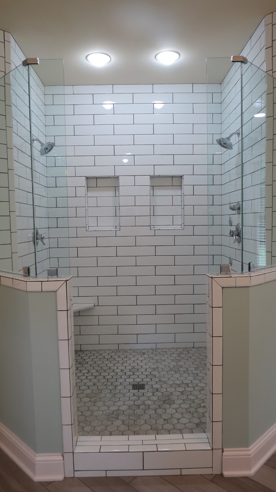 На фото: большая главная ванная комната в стиле модернизм с фасадами в стиле шейкер, белыми фасадами, отдельно стоящей ванной, двойным душем, белой плиткой, керамической плиткой, зелеными стенами, полом из керамогранита, монолитной раковиной, серым полом, открытым душем и белой столешницей