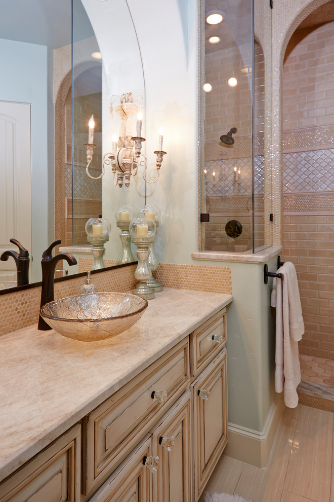 Photo of an expansive classic shower room bathroom in Dallas with shaker cabinets, distressed cabinets, an alcove shower, a one-piece toilet, blue tiles, glass tiles, beige walls, ceramic flooring, a vessel sink, granite worktops, beige floors and beige worktops.