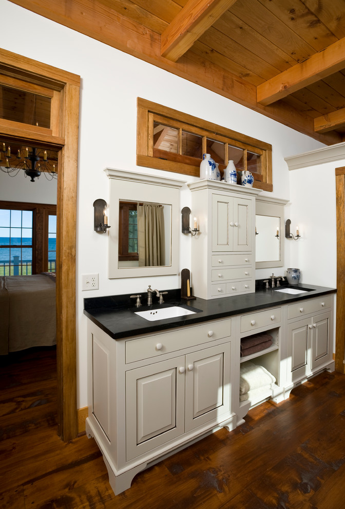 Medium sized ensuite bathroom in Burlington with white cabinets, granite worktops and medium hardwood flooring.