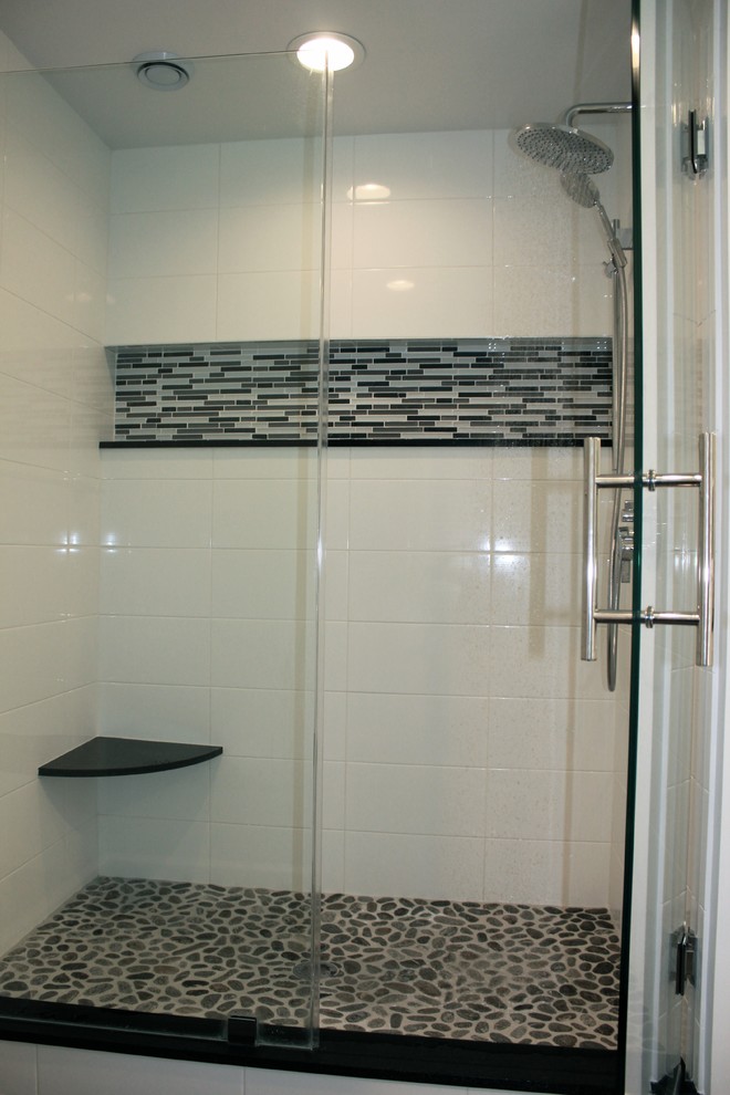This is an example of a large modern ensuite bathroom in DC Metro with a submerged sink, flat-panel cabinets, white cabinets, granite worktops, a built-in bath, a two-piece toilet, black tiles, porcelain tiles and porcelain flooring.