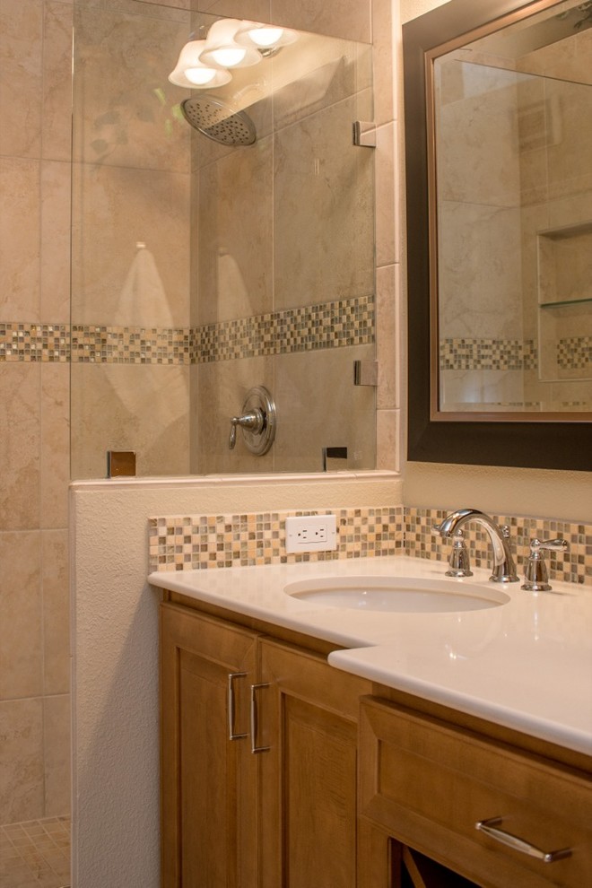 Cette photo montre une salle de bain chic avec un lavabo posé, une douche d'angle, un placard avec porte à panneau encastré, des portes de placard marrons, un plan de toilette en granite, un carrelage blanc et mosaïque.