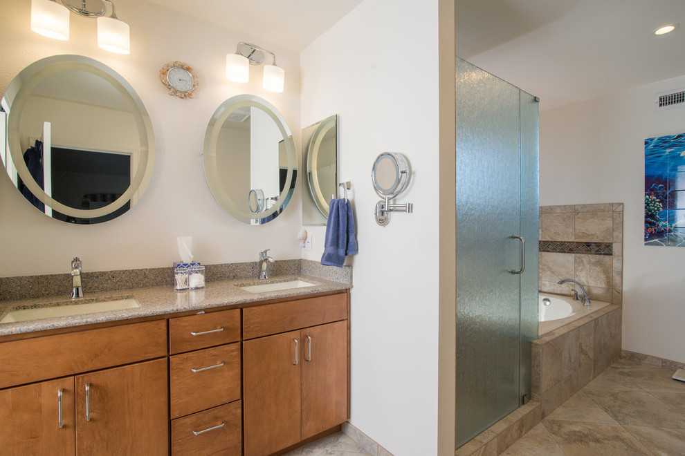 Design ideas for a medium sized traditional ensuite bathroom in San Diego with a submerged sink, raised-panel cabinets, light wood cabinets, granite worktops, a corner bath, a walk-in shower, a one-piece toilet, beige tiles, ceramic tiles, blue walls and ceramic flooring.