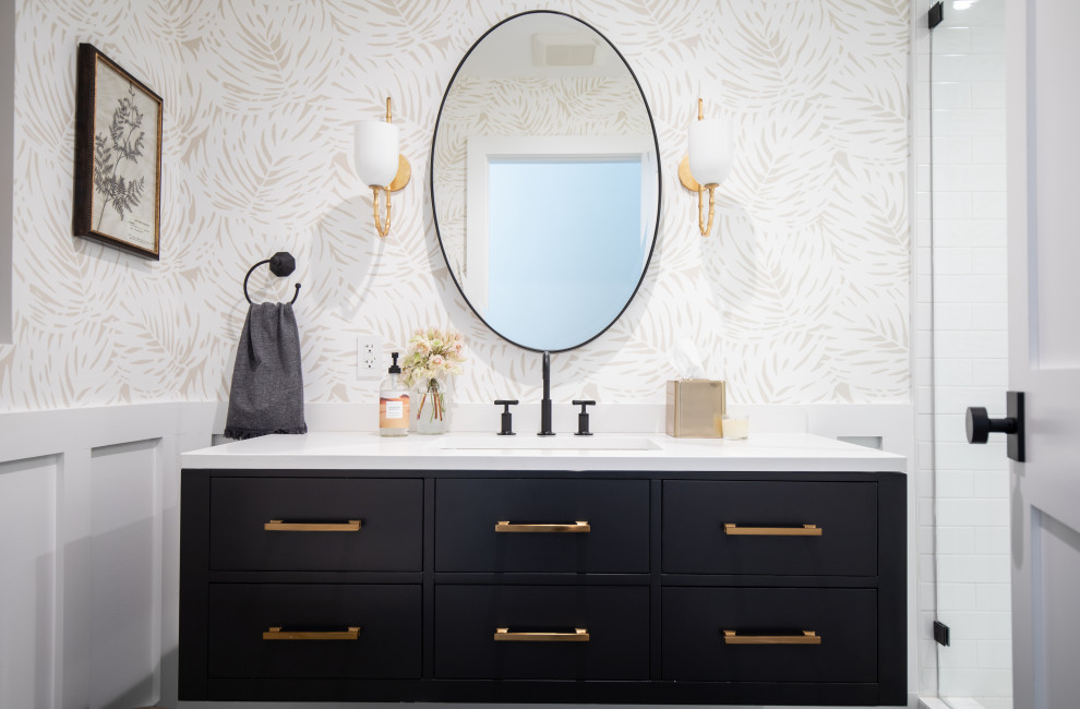Inspiration for a mid-sized transitional 3/4 white tile and ceramic tile porcelain tile and black floor bathroom remodel in Los Angeles with flat-panel cabinets, black cabinets, a one-piece toilet, white walls, an undermount sink, a hinged shower door and white countertops