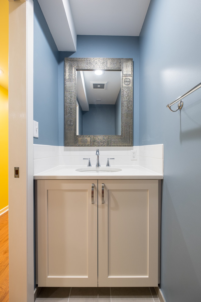 Inspiration for a mid-sized timeless master white tile and ceramic tile porcelain tile bathroom remodel in Portland with recessed-panel cabinets, white cabinets, a two-piece toilet, blue walls, an undermount sink and quartz countertops