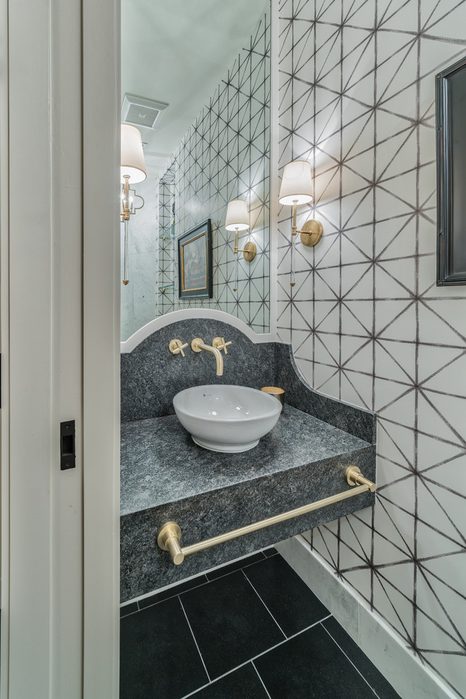 Photo of a medium sized eclectic bathroom in Las Vegas with a bidet, black and white tiles, white walls, limestone flooring, a vessel sink, limestone worktops, black floors, open cabinets and black worktops.