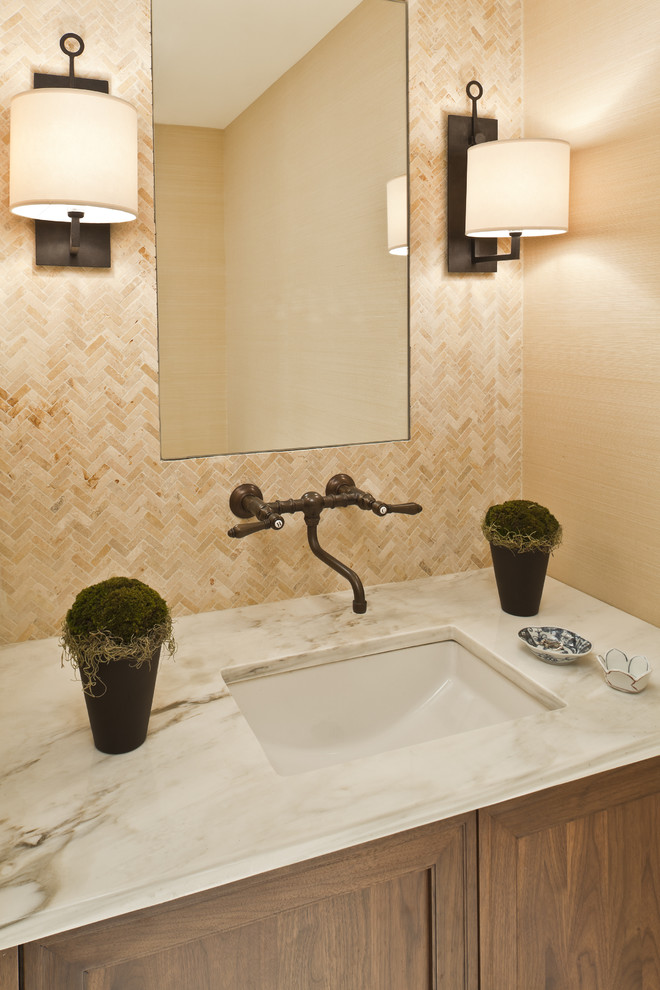 Traditional bathroom in DC Metro with a submerged sink, beige tiles, dark wood cabinets and travertine tiles.