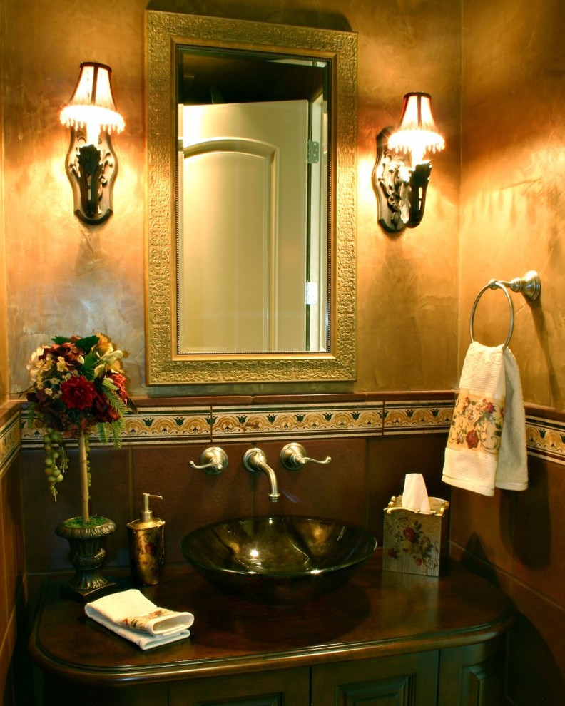 Foto di una stanza da bagno con doccia mediterranea con ante a filo, ante in legno bruno, piastrelle marroni, piastrelle in pietra, pareti marroni, lavabo integrato e top piastrellato