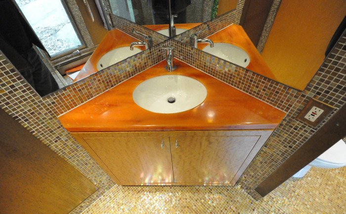 This is an example of a small eclectic shower room bathroom in New York with flat-panel cabinets, beige cabinets, a corner shower, a two-piece toilet, multi-coloured tiles, mosaic tiles, multi-coloured walls, mosaic tile flooring, a submerged sink, laminate worktops, multi-coloured floors and a hinged door.