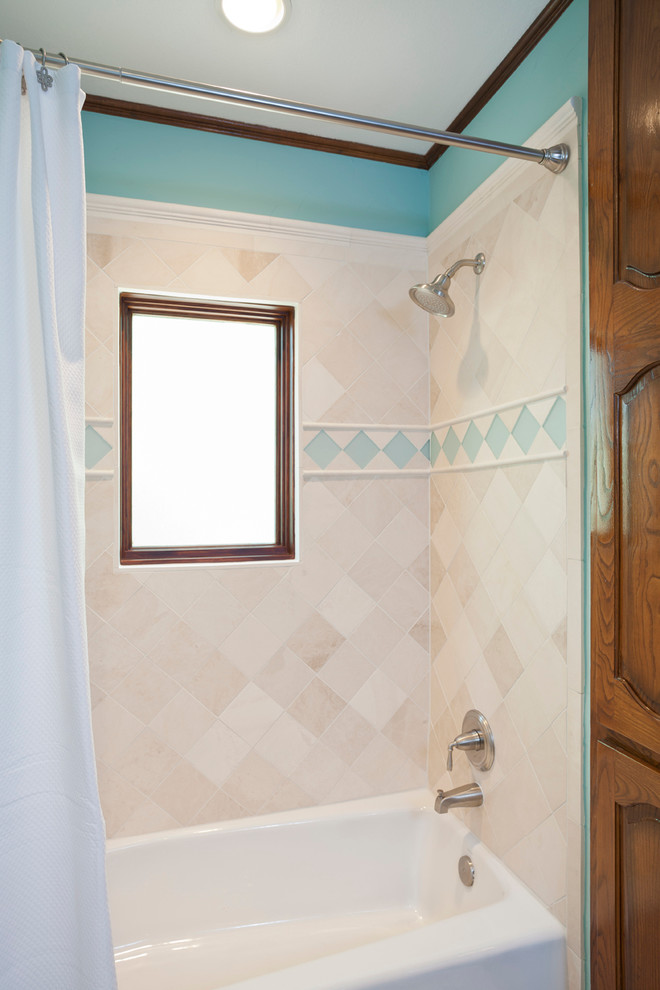 Photo of a traditional shower room bathroom in Austin with a pedestal sink, raised-panel cabinets, dark wood cabinets, a built-in bath, a walk-in shower, a two-piece toilet, blue tiles, blue walls and travertine flooring.