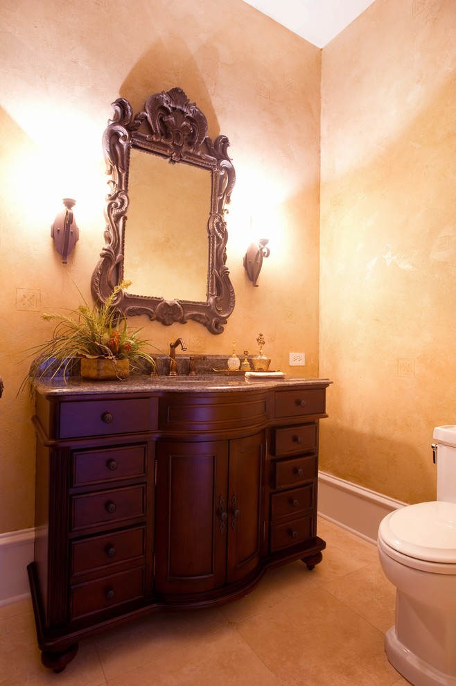 Idées déco pour une salle d'eau classique en bois foncé de taille moyenne avec un placard en trompe-l'oeil, WC à poser, un mur jaune, un sol en carrelage de porcelaine, un lavabo encastré, un plan de toilette en granite et un sol beige.