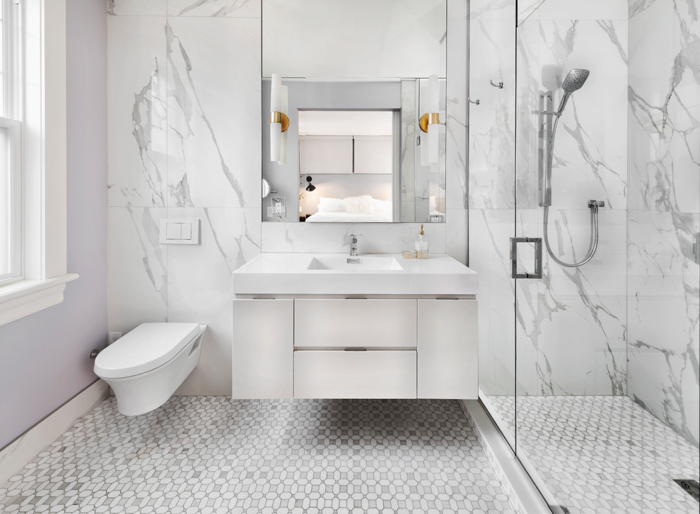 Photo of a contemporary bathroom in Ottawa with flat-panel cabinets, white cabinets, an alcove shower, a wall mounted toilet, white tiles, purple walls, an integrated sink, grey floors and white worktops.