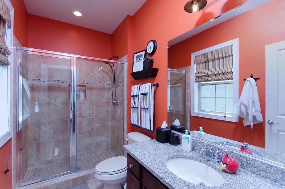 Small kids' ceramic tile ceramic tile doorless shower photo in DC Metro with shaker cabinets, dark wood cabinets, a two-piece toilet, orange walls, an undermount sink and granite countertops