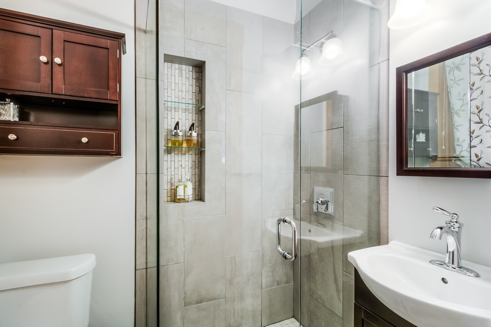 Small traditional shower room bathroom in Boston with a corner shower, a two-piece toilet, grey tiles, porcelain tiles, grey walls and an integrated sink.
