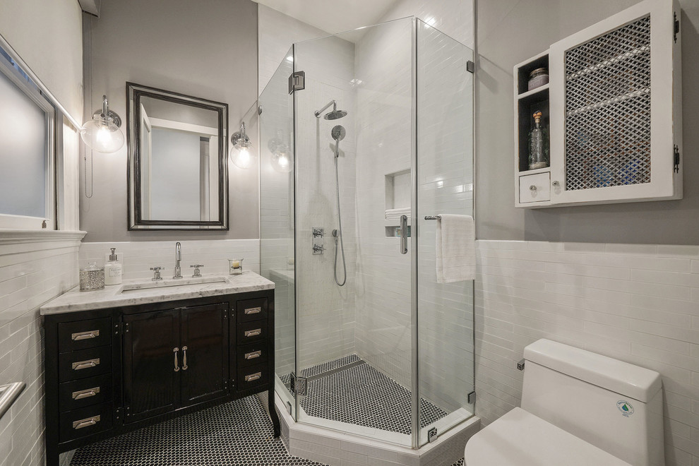 This is an example of a traditional shower room bathroom in San Francisco with black cabinets, a corner shower, white tiles, metro tiles, grey walls, mosaic tile flooring, a submerged sink, marble worktops, black floors, a hinged door, white worktops and shaker cabinets.