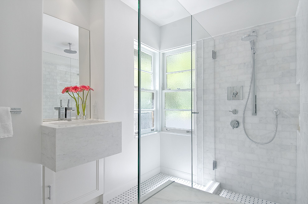 This is an example of a contemporary bathroom in San Francisco with a submerged sink, recessed-panel cabinets, white cabinets, a corner shower, white tiles and metro tiles.
