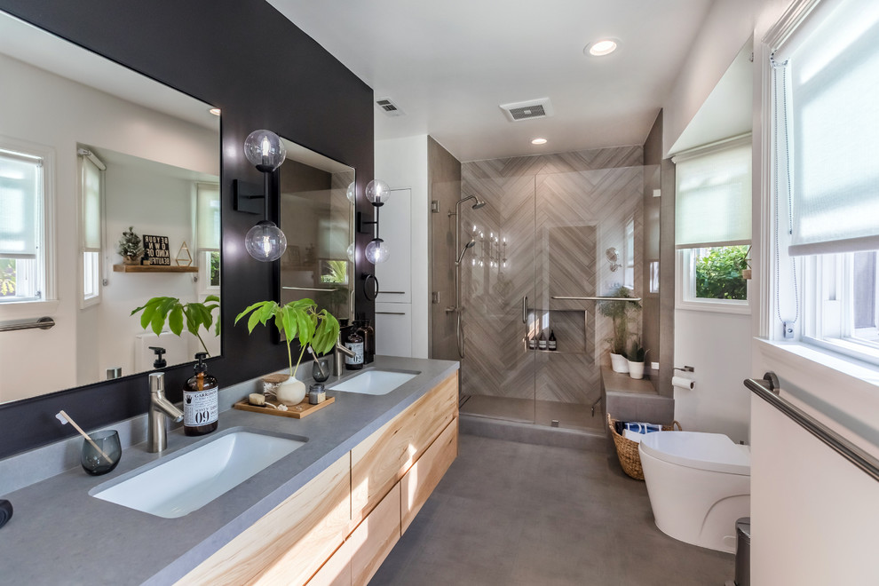 Alcove shower - mid-sized scandinavian master gray tile and porcelain tile porcelain tile and gray floor alcove shower idea in Los Angeles with furniture-like cabinets, light wood cabinets, a two-piece toilet, multicolored walls, an undermount sink, quartz countertops and a hinged shower door