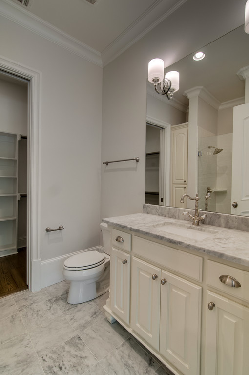 Example of a mid-sized classic 3/4 white tile and subway tile marble floor bathroom design in Dallas with raised-panel cabinets, white cabinets, a one-piece toilet, gray walls, a drop-in sink and marble countertops