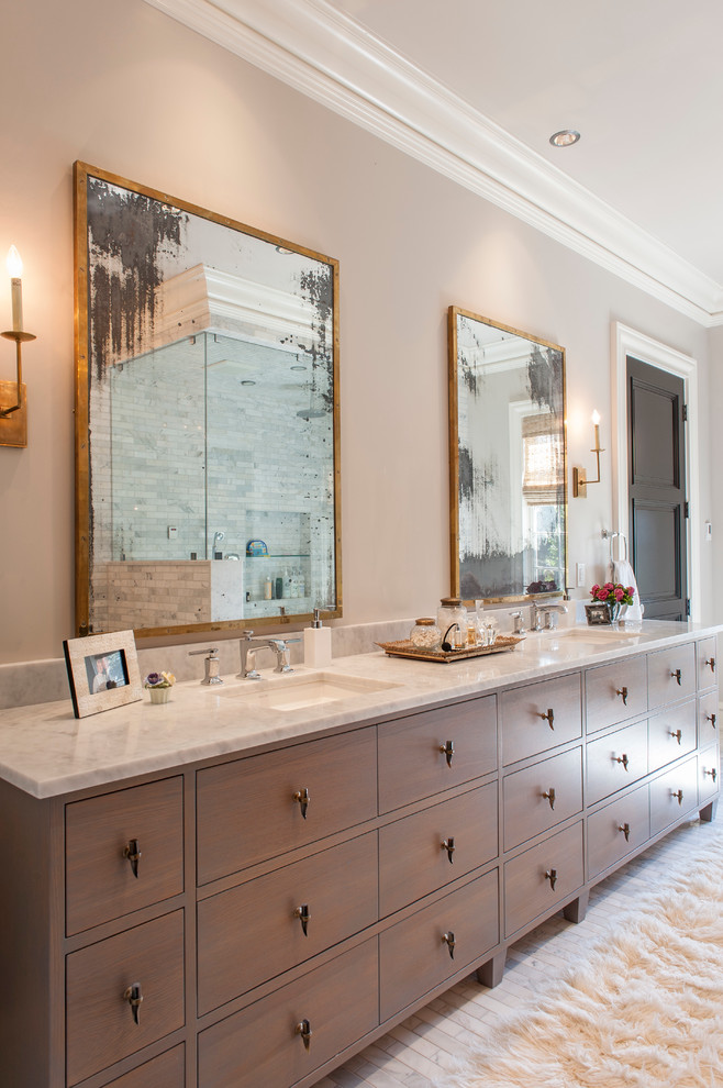 This is an example of a large classic ensuite bathroom in Indianapolis with a submerged sink, medium wood cabinets, marble worktops, a two-piece toilet, white tiles, stone tiles, beige walls, marble flooring and flat-panel cabinets.