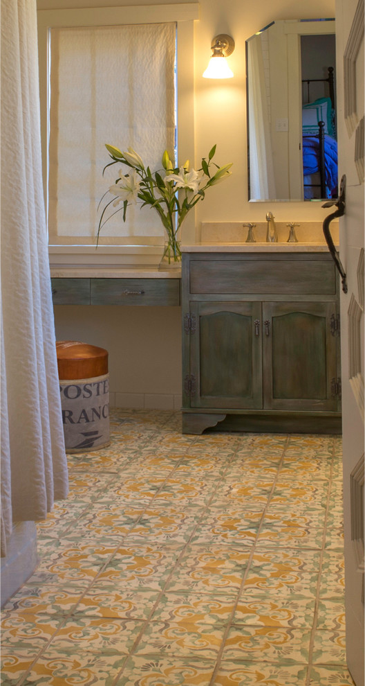 Design ideas for a medium sized rustic family bathroom in Albuquerque with a submerged sink, recessed-panel cabinets, distressed cabinets, engineered stone worktops, a built-in bath, a shower/bath combination, multi-coloured tiles, terracotta tiles, beige walls and terracotta flooring.