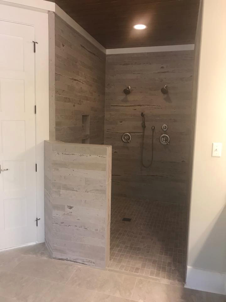 Inspiration for a large rural ensuite bathroom in Other with shaker cabinets, white cabinets, double sinks, a built in vanity unit, a freestanding bath, an alcove shower, granite worktops, an open shower, grey worktops, beige walls, ceramic flooring, a submerged sink, beige floors, a wall niche and a wood ceiling.