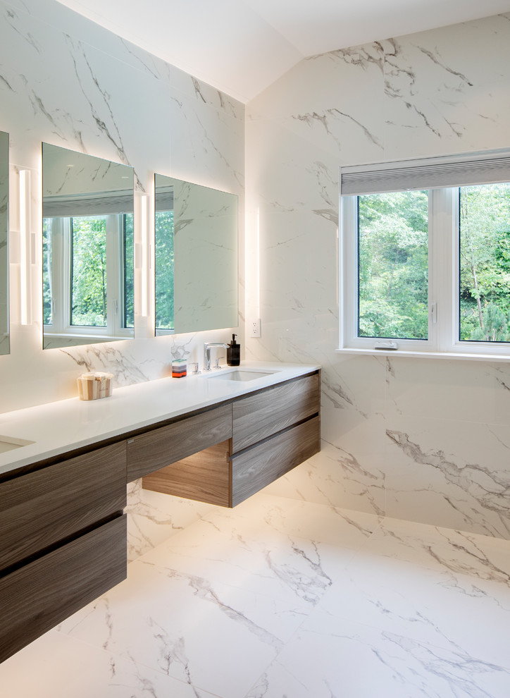 Large contemporary ensuite bathroom in Vancouver with louvered cabinets, a one-piece toilet, white tiles, ceramic tiles, white walls, a submerged sink, a hinged door, medium wood cabinets, a corner shower, ceramic flooring, white floors and white worktops.
