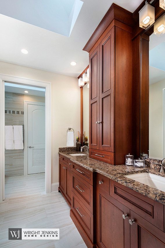 Large beach style shower room bathroom in Tampa with beaded cabinets, brown cabinets, a double shower, a two-piece toilet, beige tiles, travertine tiles, beige walls, travertine flooring, a submerged sink, granite worktops, beige floors, a sliding door and brown worktops.
