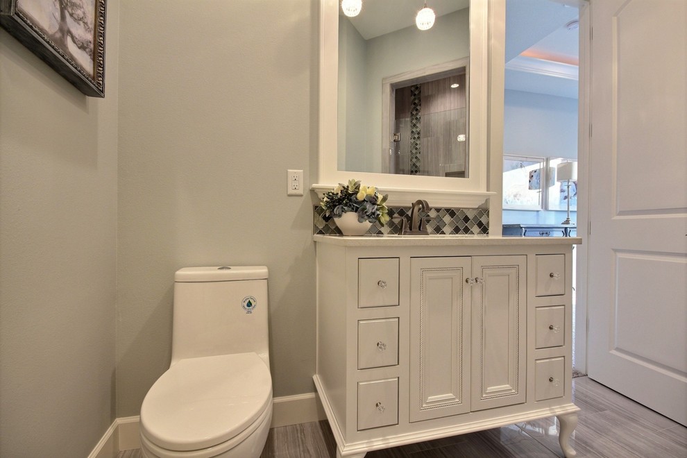 Example of a huge transitional master multicolored tile and stone tile marble floor alcove shower design in Portland with recessed-panel cabinets, dark wood cabinets, a one-piece toilet, gray walls, an undermount sink and quartzite countertops